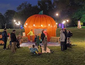 Giant Inflatable Pumpkin with people standing around